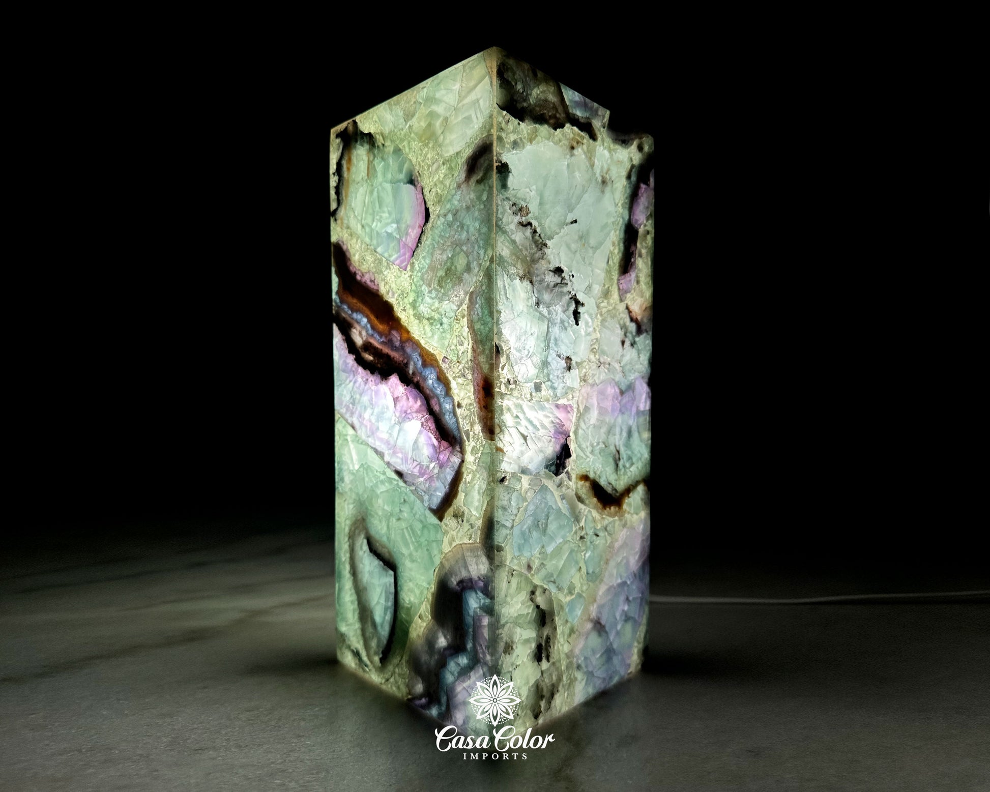 Fluorite Crystal lamp. The colors are green, blues, blacks and white. The size is 12" high and 4" wide.