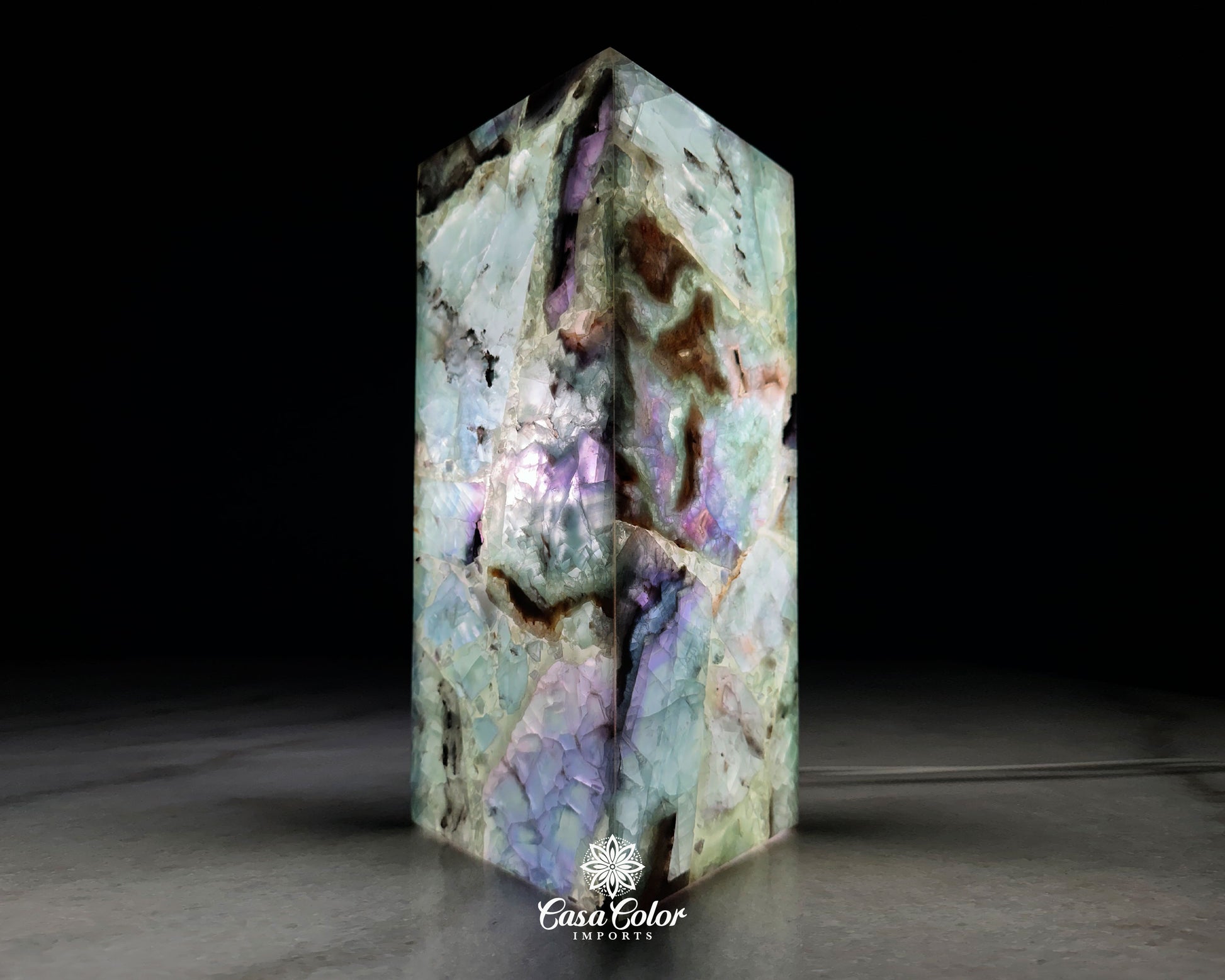 Fluorite Crystal lamp. The colors are green, blues, blacks and white. The size is 12" high and 4" wide.