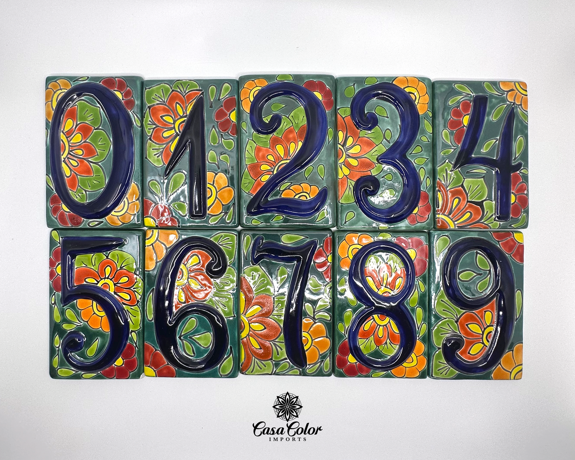 Mexican Talavera street address numbers. The tile numbers are blue painted in relief with a flower background. The size of the tiles is 3.5' wide and 5.5 high.  