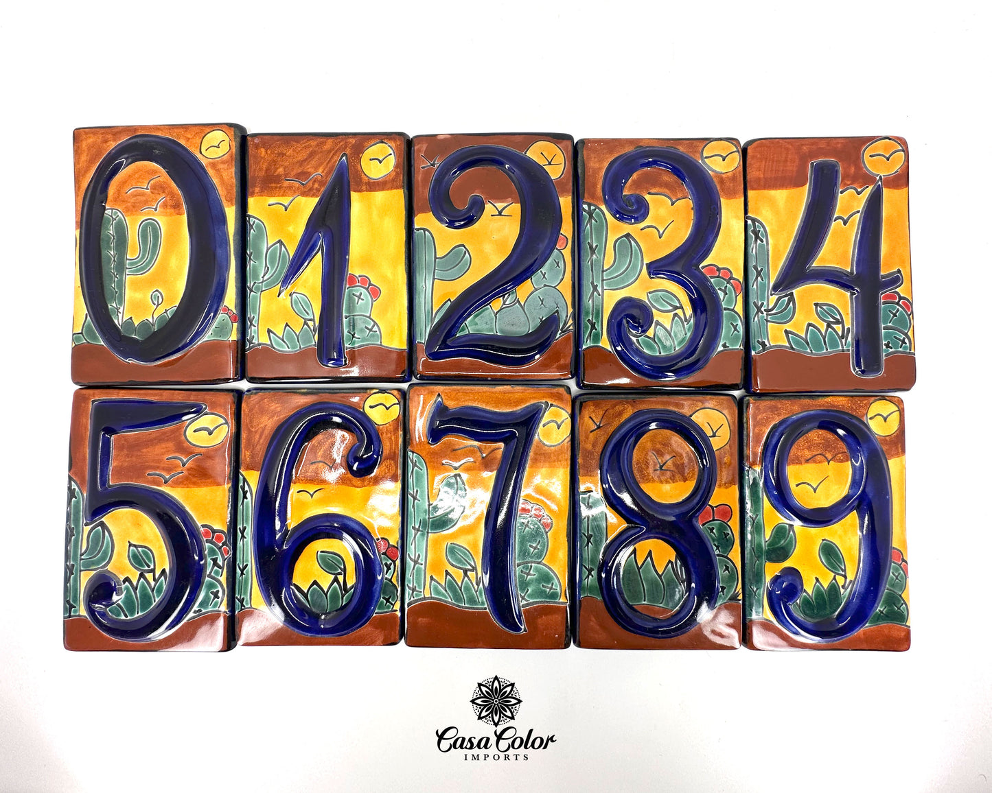 Mexican Talavera Street numbers. The design is a picture of the desert with cactuses in the background. The letters are blue. Size is 5.5 inches X 3.5 inches.