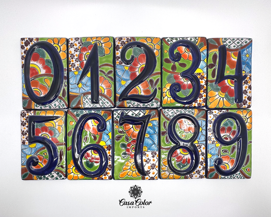 House of street numbers made of of handmade Mexican Talavera tile. The numbers are painted in a relief  blue 0 to 1 with a background  of  flowers of different colors. The sizes are 4.5 by 3.5 inches. 