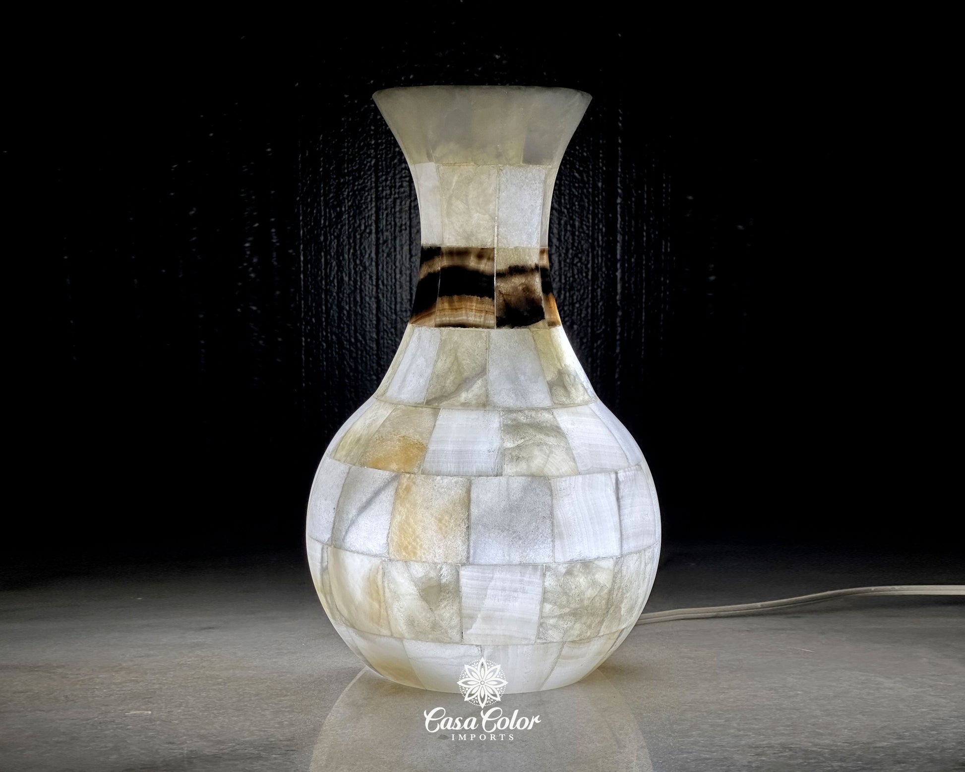 Onyx white vase lamp with soft shades of brown and silver. 5 in. Width (Top) x 7.5 in. Width (Base) x 13 in. Height