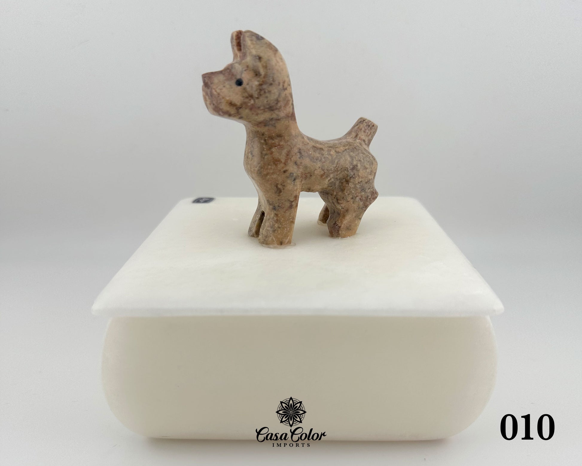 Sophisticated white onyx dog jewelry box. The urn is 10.5 L x 5 W x4 L inches. The hand carved marble dog statue is beige with white veins