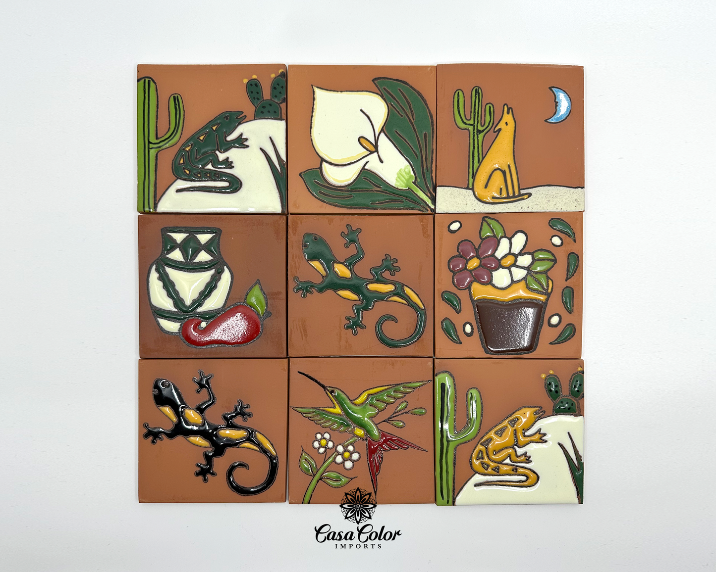 Desert collection handmade tile, each tile is 4x4 inches with clay surface and hand painted relief glossy figures. Each tile has a different picture. The pictures are the following: Green frog, white flower, mustard wolf, flower based with a red pepper, green lizard with mustard spots, flower based with flowers, black lizard with mustard spots, hummingbird, and green frog with cactus.  