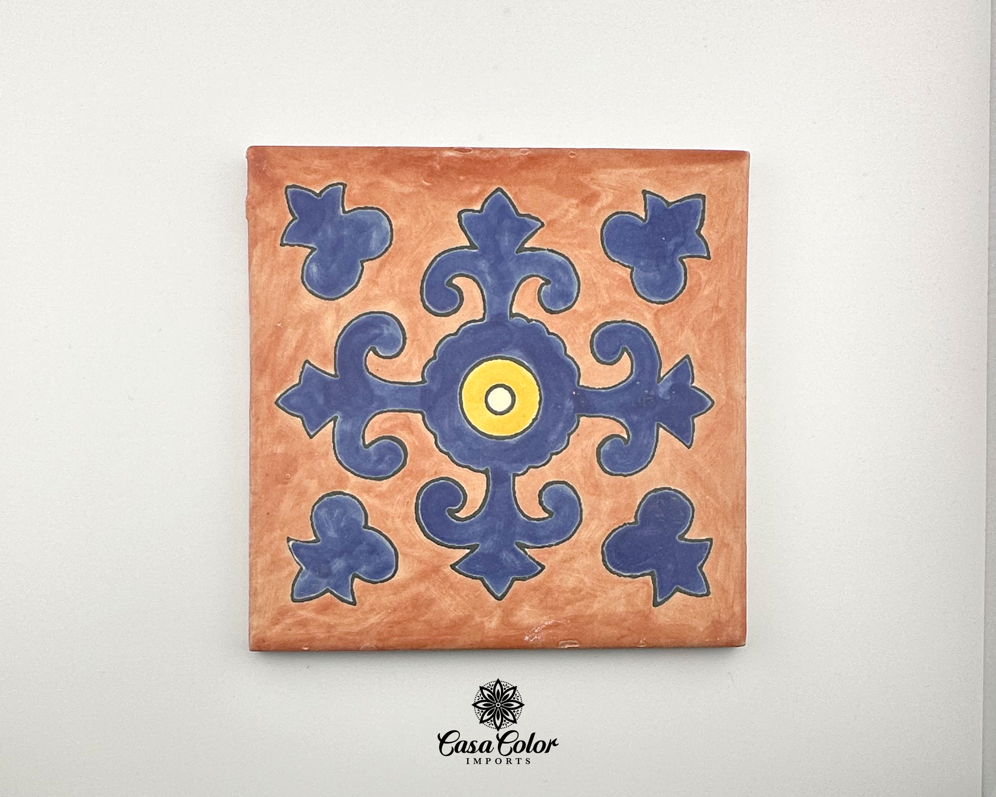 Tile for indoor and outdoor. 6x6 inches. This tile is handmade and painted by hand with a brush. The colors are light brown background with a flower in the shape of a cross blue with yellow center.