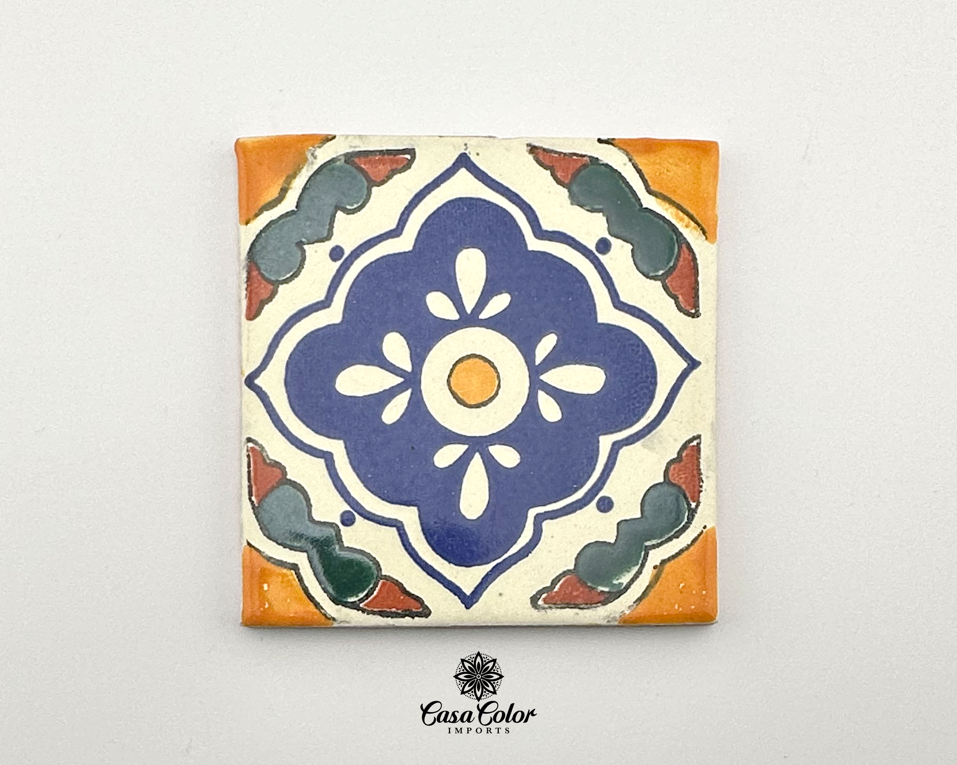 Mexican Talavera Tile with blue flower in the middle. The colors are blue, mustard and white. The size is 4x4 inches.