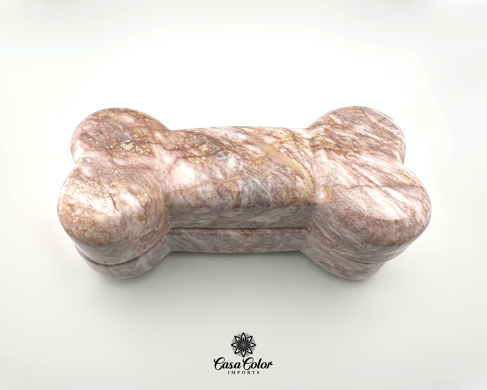 Pet Urn in the shape of a bone made of Onyx rock. The rock onyx is white full of 75 to 100 lb. Measurements are 9 inch long, 4 inch wide, and 3 inch high.  The onyx rock has a natural white color with pink veins around it. This is for a 100 lb. dog.